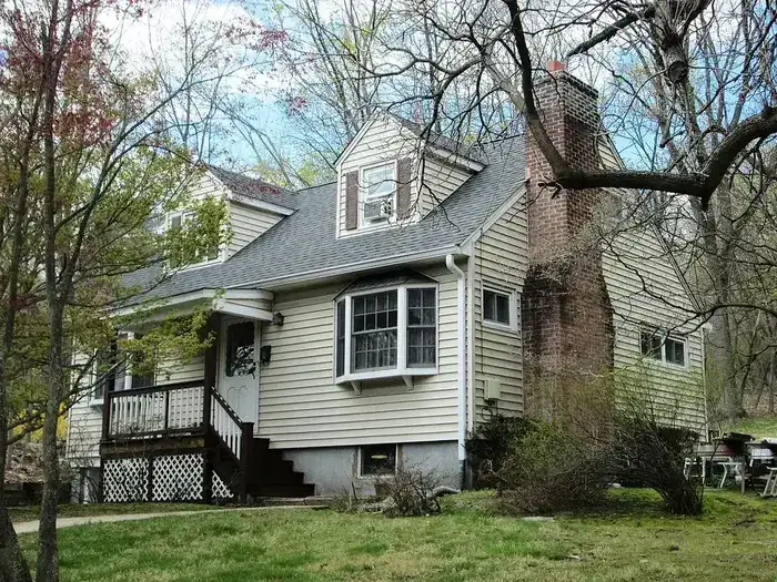 Postwar Cape Cod style home in Westport CT typical of 1940s-1970s housing stock